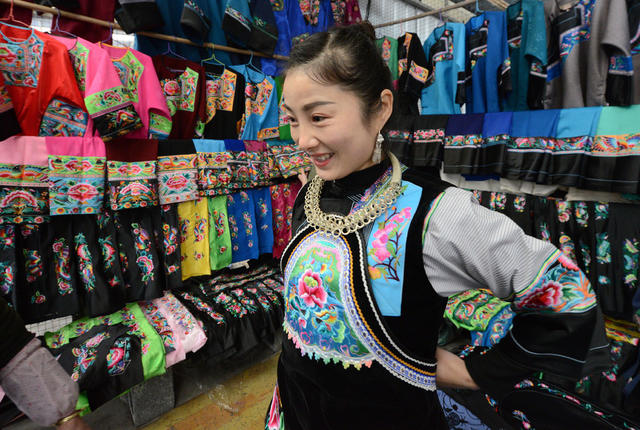 集市   苗家 妇女 挑选 苗服 鞋帽 银饰 民族 传统 迎 新春 
